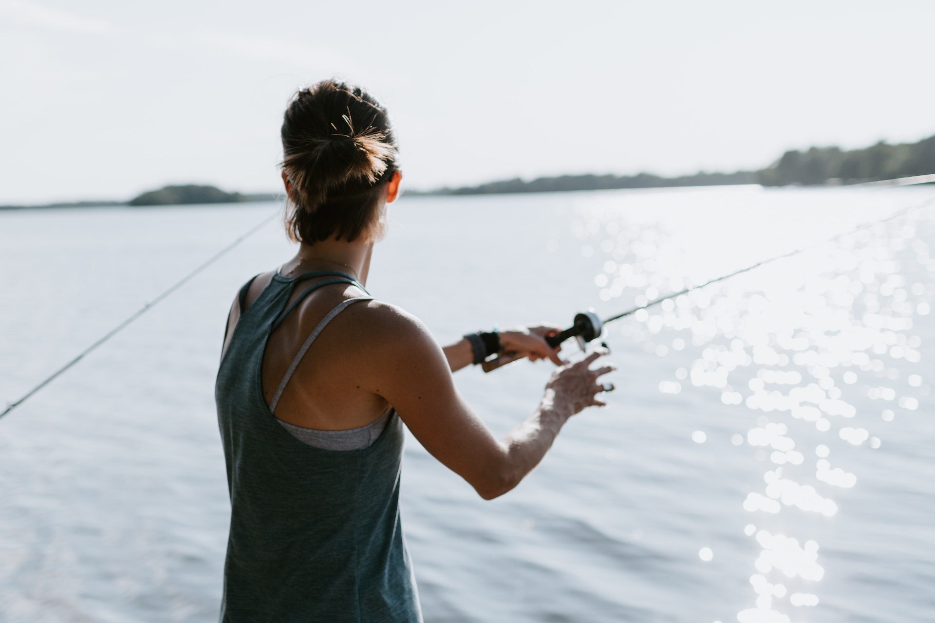 Woman fishing into a lake